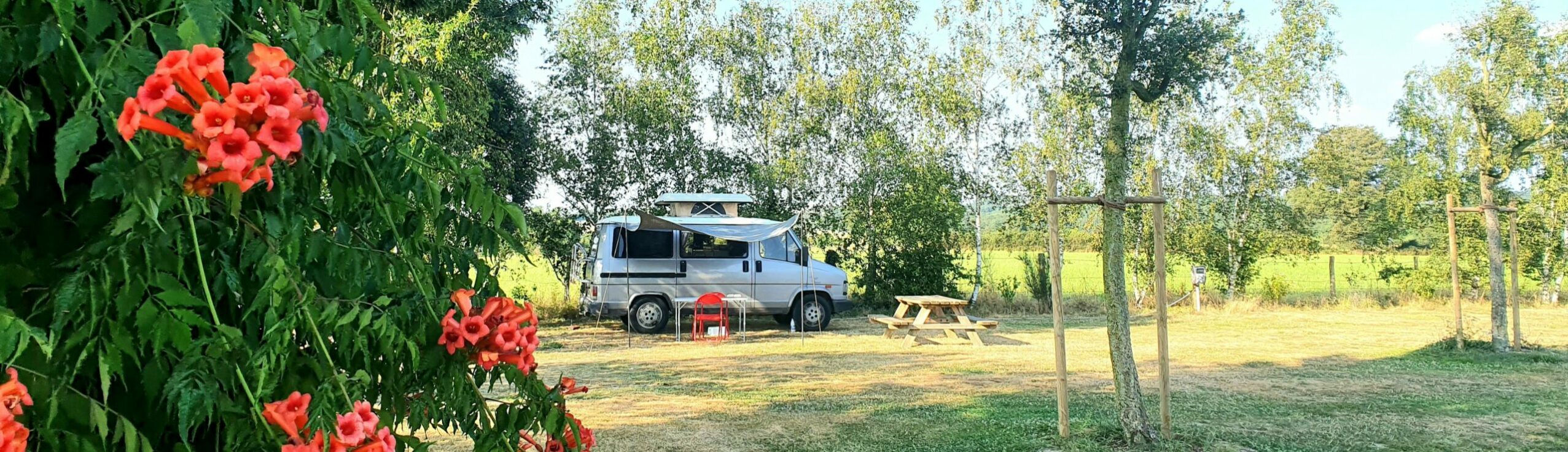 esprit van lifer avec fourgon aménagé dans la prairie derrière la salle
